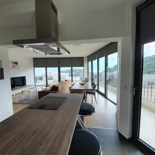 a living room with a table and chairs and a couch at Blue Water Apartment in Korčula