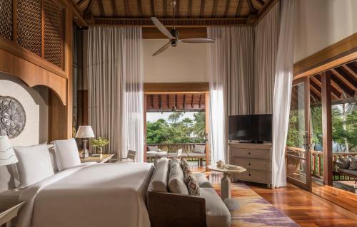 a living room filled with furniture and a tv at Four Seasons Resort Langkawi in Tanjung Rhu