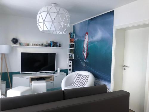 a living room with a couch and a television at Prerow „Seaside“-strandnah! in Prerow