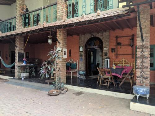 a house with a patio with a table and chairs at Bohemyan Blue Stay in Alibaug