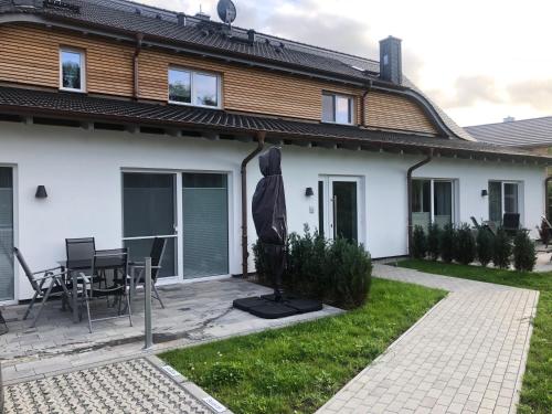 a house with a patio and a table at Prerow „Seaside“-strandnah! in Prerow