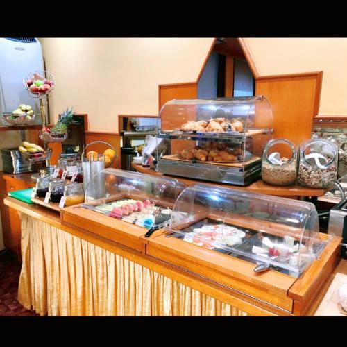 a buffet line with pastries and other food items at Hotel Aragia in Klagenfurt
