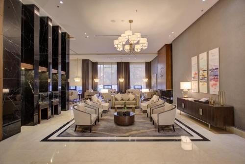 a lobby with a waiting room with chairs and a chandelier at The House Boutique Suites in Amman