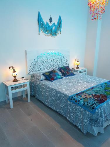 ein Schlafzimmer mit einem Bett und zwei Nachttischen in der Unterkunft La Naval 209, 4ºB - AGADIR - in Las Palmas de Gran Canaria
