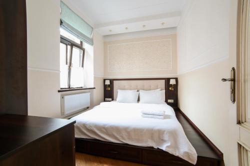 a bedroom with a large bed with white sheets at Апартаменти з балконом (2 ізольовані спальні) в центрі Львова in Lviv