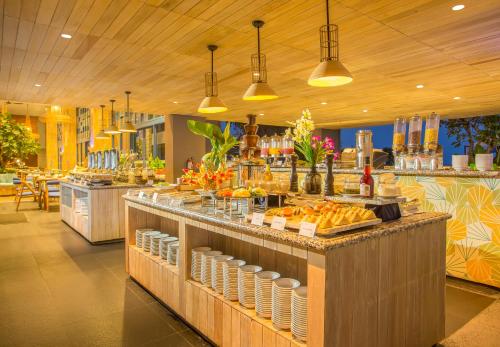 a buffet line in a restaurant with food on display at Swiss-Belresort Belitung in Tanjungbinga