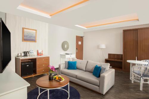 a living room with a couch and a table at Swiss-Belresort Belitung in Tanjungbinga