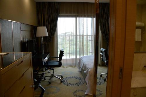 a hotel room with a bed and a window at Hotel Anda China Malabo in Malabo
