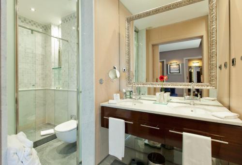 a bathroom with a sink and a toilet and a mirror at Hotel Casa Fuster G.L Monumento in Barcelona