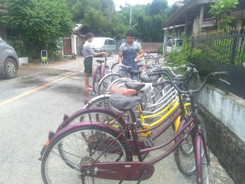 a group of bikes parked on the side of a street at Moonlight Champa Riverview in Luang Prabang