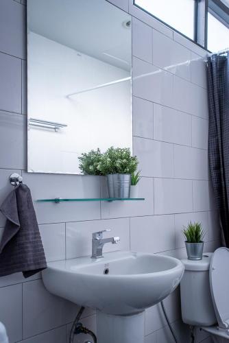 a white bathroom with a sink and a toilet at T5 2 Bedrooms/6guests/full kitchen/1 min to BTS in Bangkok