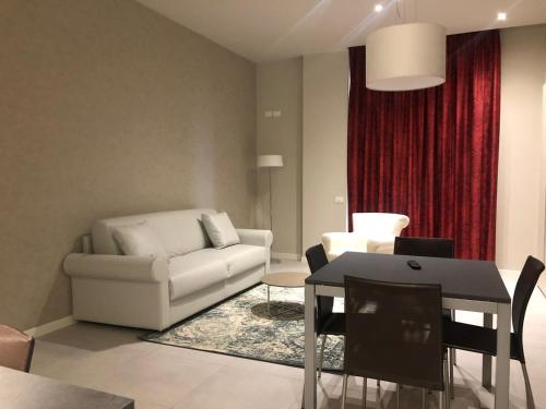 a living room with a white couch and a table at Zanhotel Regina in Bologna