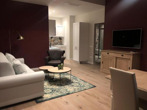 a living room with a white couch and a table at Zanhotel Regina in Bologna