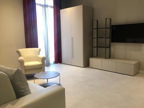 a living room with a couch and a tv at Zanhotel Regina in Bologna