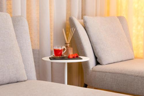 a cup of tea on a tray next to two chairs at Maritim Hotel Plaza Tirana in Tirana