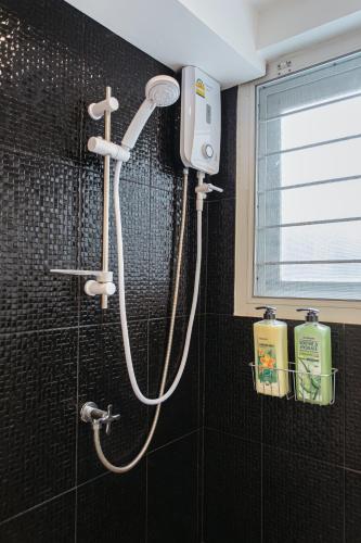 a shower in a bathroom with a shower head at B2 Large + Comfort full kitchen near MRT Bangson in Bangkok