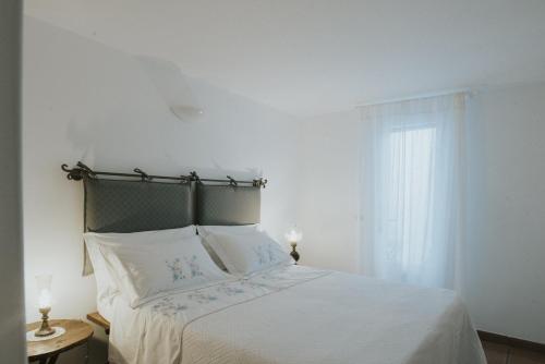 Un pat sau paturi într-o cameră la Trulli d'Itria