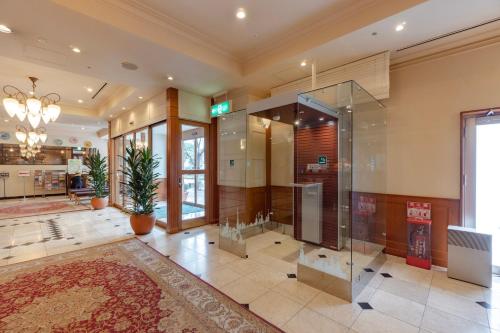 a large bathroom with a shower and a glass door at Hotel Gimmond Kyoto in Kyoto