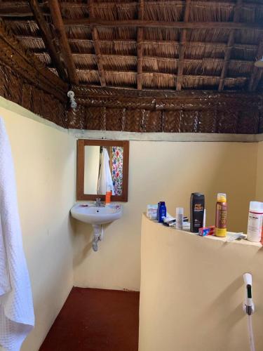 a bathroom with a sink and a mirror at Juani beach bungalows in Kilindoni