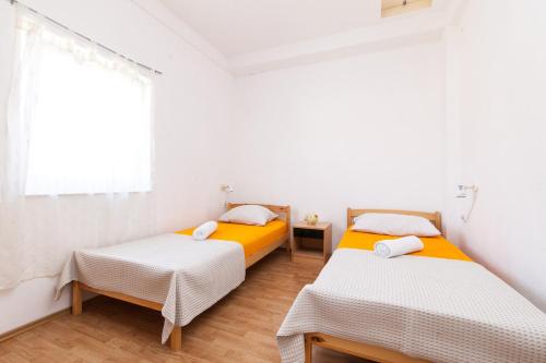Posteľ alebo postele v izbe v ubytovaní Kuća Ella