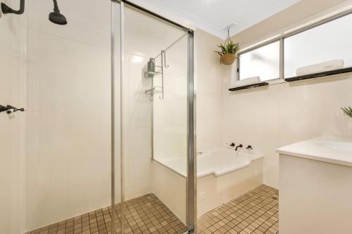 a bathroom with a shower and a sink at Memories On Mount View, Games Room, Cosy Wood Fire, Netflix in Cessnock