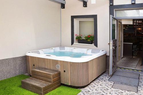 a jacuzzi tub in the corner of a room at Butella Apartman Eger in Eger