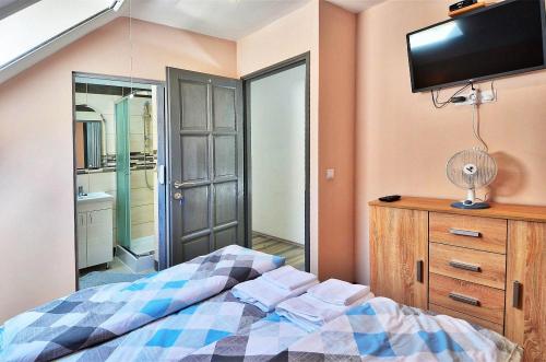 A bed or beds in a room at Butella Apartman Eger
