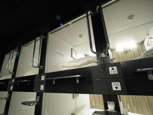 a room with a window with a bed in it at LEO YU Capsule Hotel Nishifunabashi in Funabashi