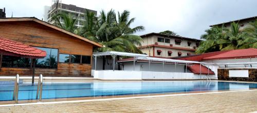 a swimming pool in front of a building at The Cape Hotel in Monrovia