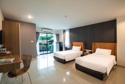 A bed or beds in a room at Jira Boutique Residence