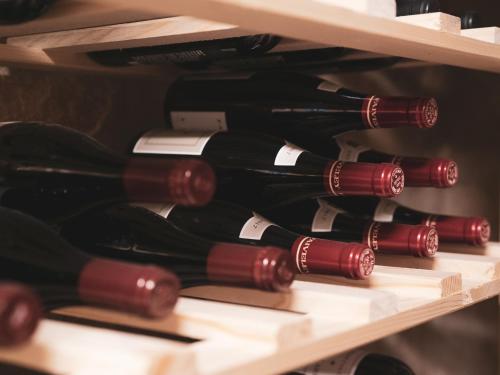 a bunch of wine bottles on a shelf at Hotel-Restaurant La Croix d’Or in Ballaigues