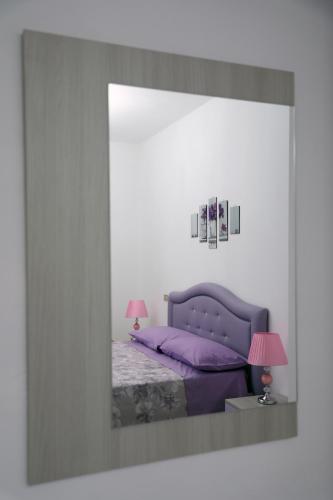 a picture of a bedroom with a purple bed at Affitta Camere Romy in Tropea