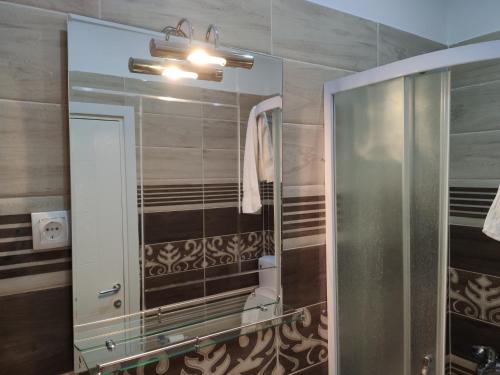 a bathroom with a large mirror and a sink at Luna in Prokuplje