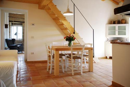 a kitchen and dining room with a table and chairs at Castello di Granarola Relais - Adults Friendly - in Gradara