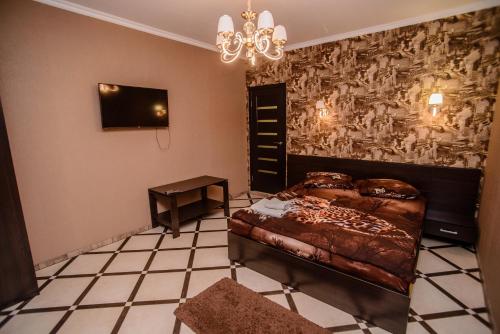 1 dormitorio con cama y lámpara de araña en Хуторок, en Smila