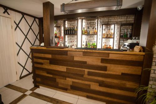 a bar in a restaurant with a wooden wall at Хуторок in Smila
