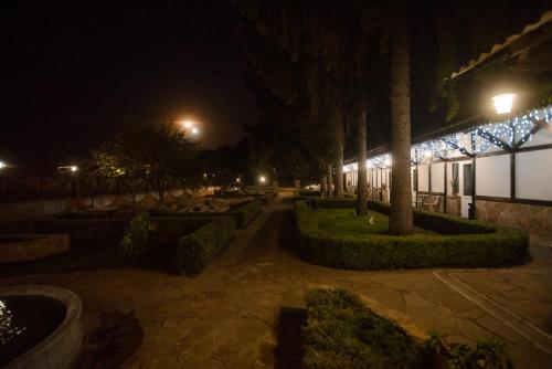 a courtyard at night with a building with lights at Хуторок in Smila