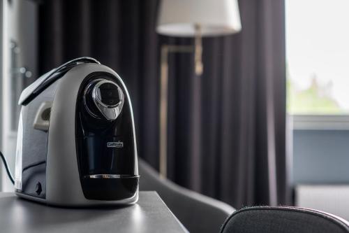 a black and white iron sitting on a table at Quality Hotel Galaxen in Borlänge