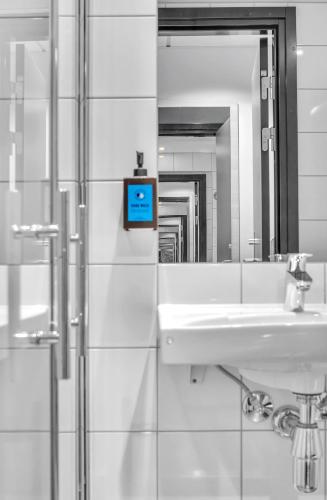 a bathroom with a sink and a mirror at Comfort Hotel Xpress Tromsø in Tromsø
