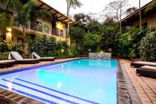 a swimming pool with lounge chairs and a resort at Forest Lodge in St Lucia