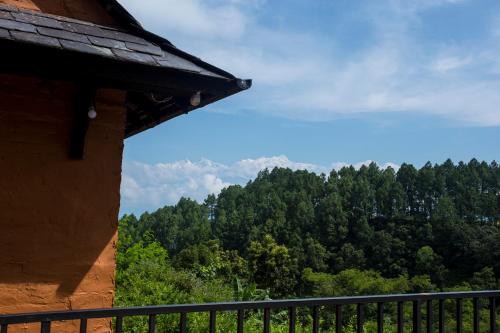 a view of a forest from a balcony of a house at Depche Village Resort in Bandīpur