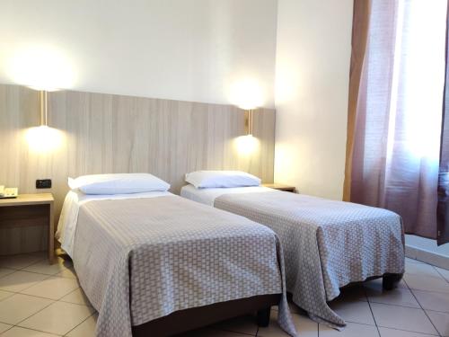 Postel nebo postele na pokoji v ubytování Hotel Mondial