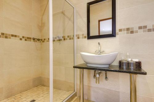 a bathroom with a sink and a shower at Forest Lodge in St Lucia
