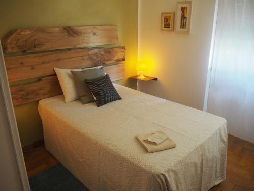 a bedroom with a bed with a towel on it at a casa di Narciso e Margherita in Foligno