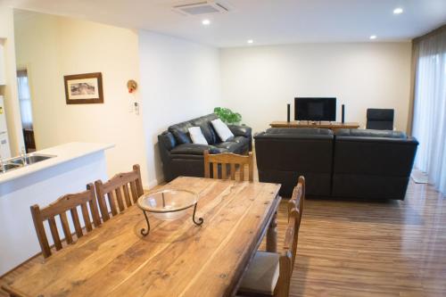 a living room with a table and a couch at Longreach at Port Elliot in Port Elliot