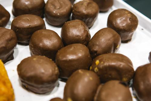 a bunch of chocolate covered donuts on a tray at Olarain in Donostia-San Sebastián
