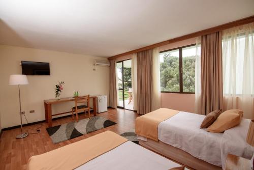 Postel nebo postele na pokoji v ubytování Hotel del Valle Azapa