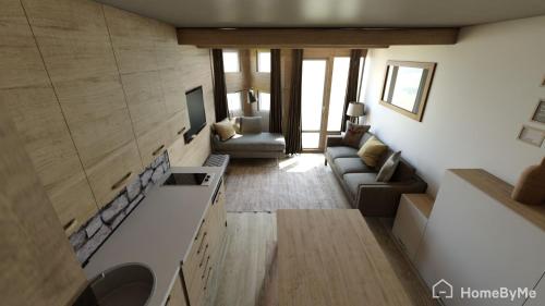 a living room with a couch and a tv at White Paradise in Val dʼIsère