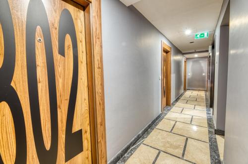 a hallway with a wooden door and a tile floor at Grisverde Suites in Istanbul