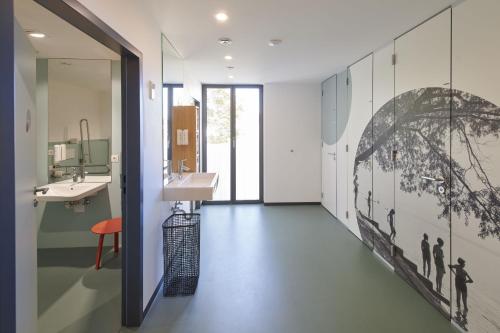 a bathroom with a sink and a mirror at Radhotel am Gleis in Radolfzell am Bodensee